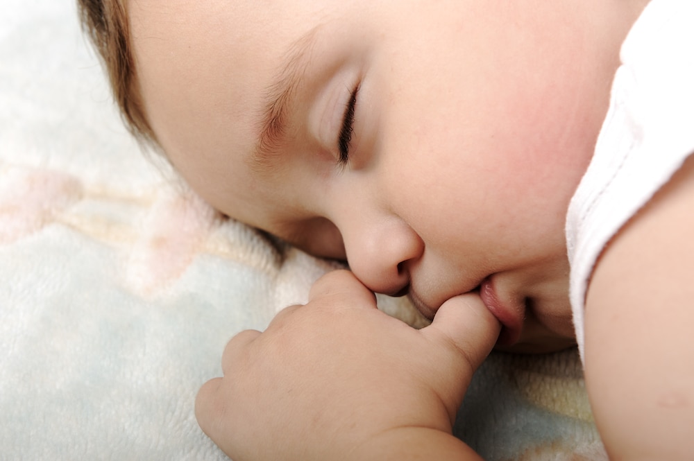 baby sleeping sucking thumb